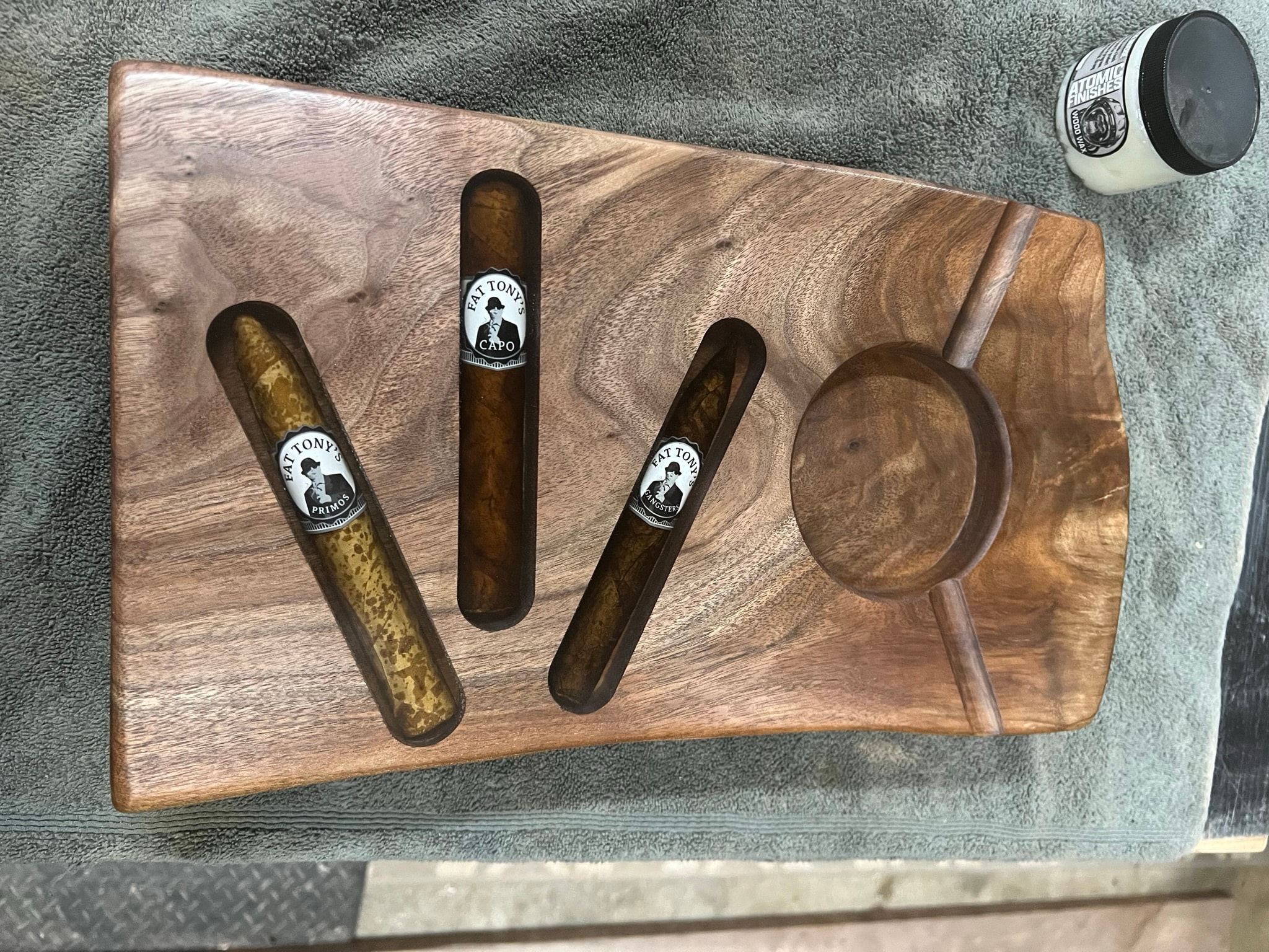 Walnut cigar serving board with routed slots and ash bowl